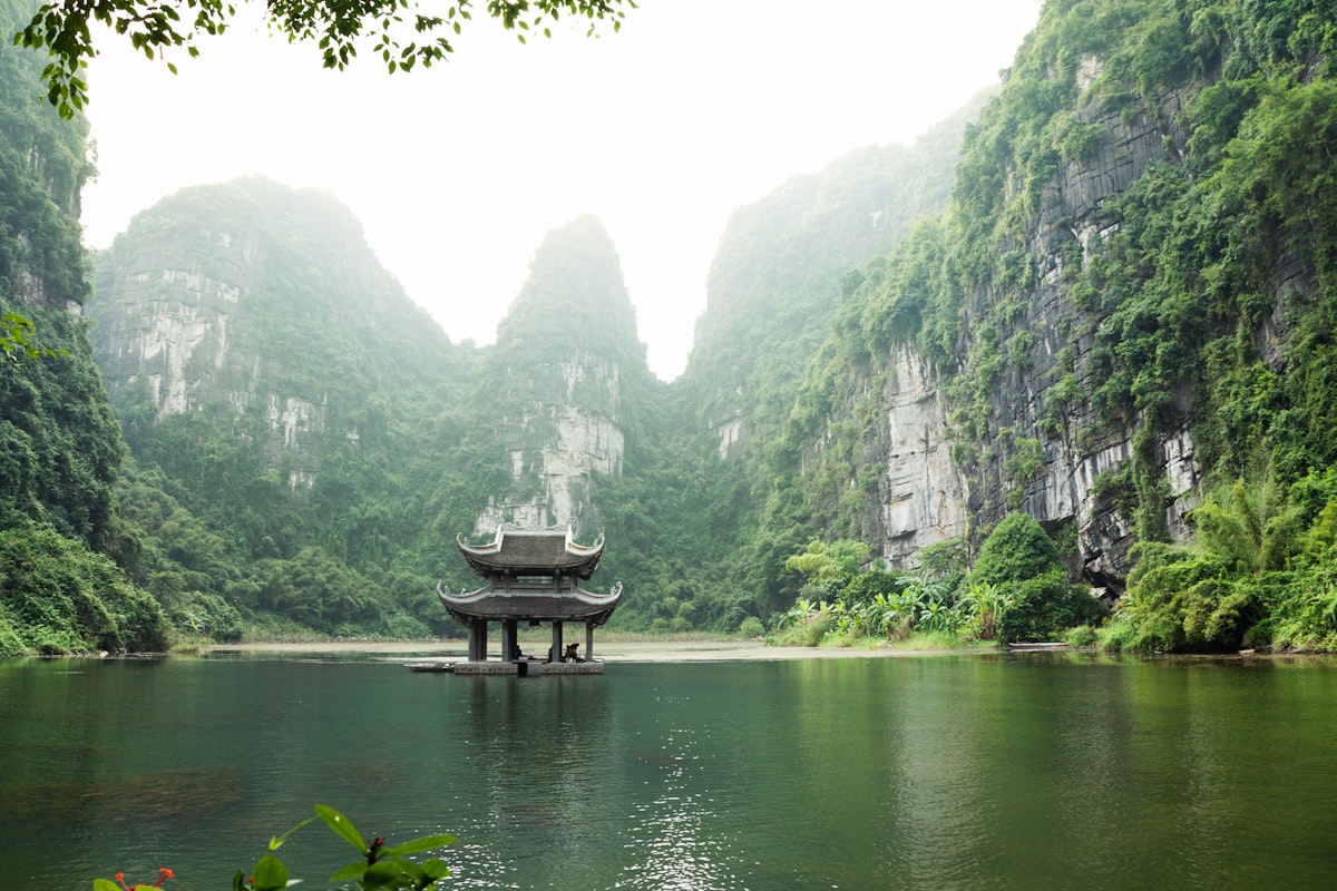 Vietnam travel costs 2026 — misty karst mountains and pagoda in Ninh Binh | tripbudgetcalculator.com